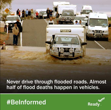 Photo of a truck and camper driving into a flooded road