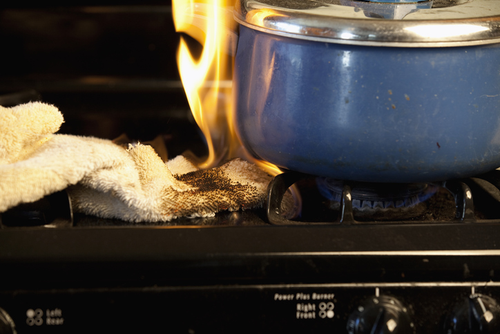 Photo of a towel on fire on the stove top