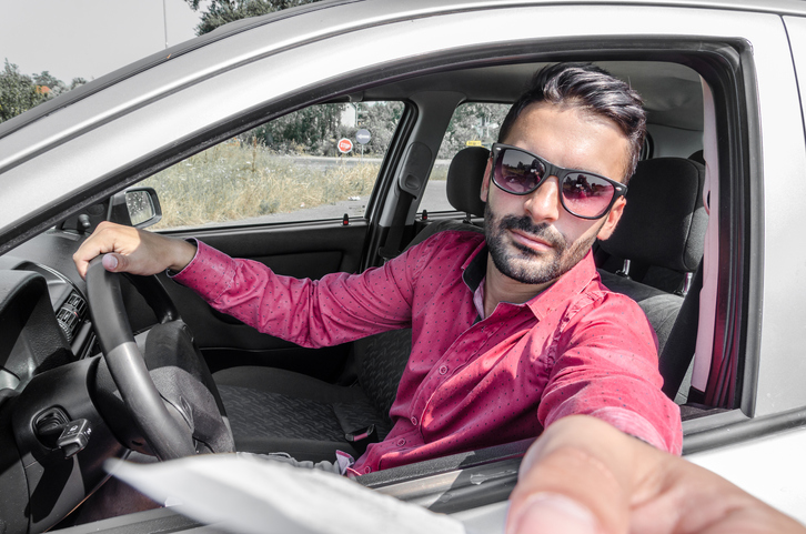 Photo of a man paying at a toll booth.