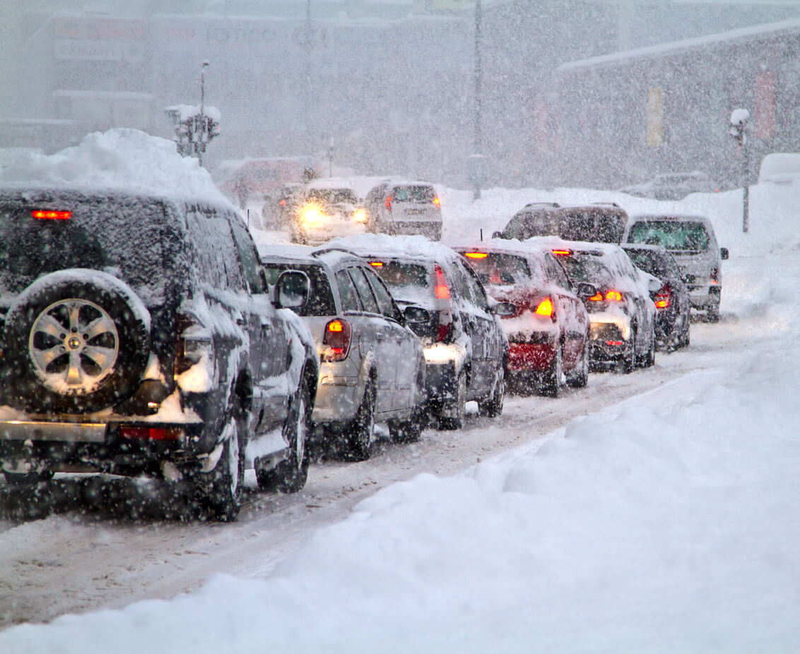 Photo of cars driving on a snowy road