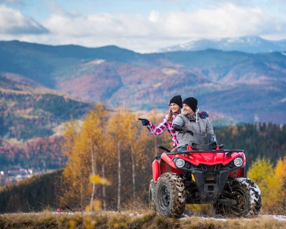 Couple in mountains on an ATV.