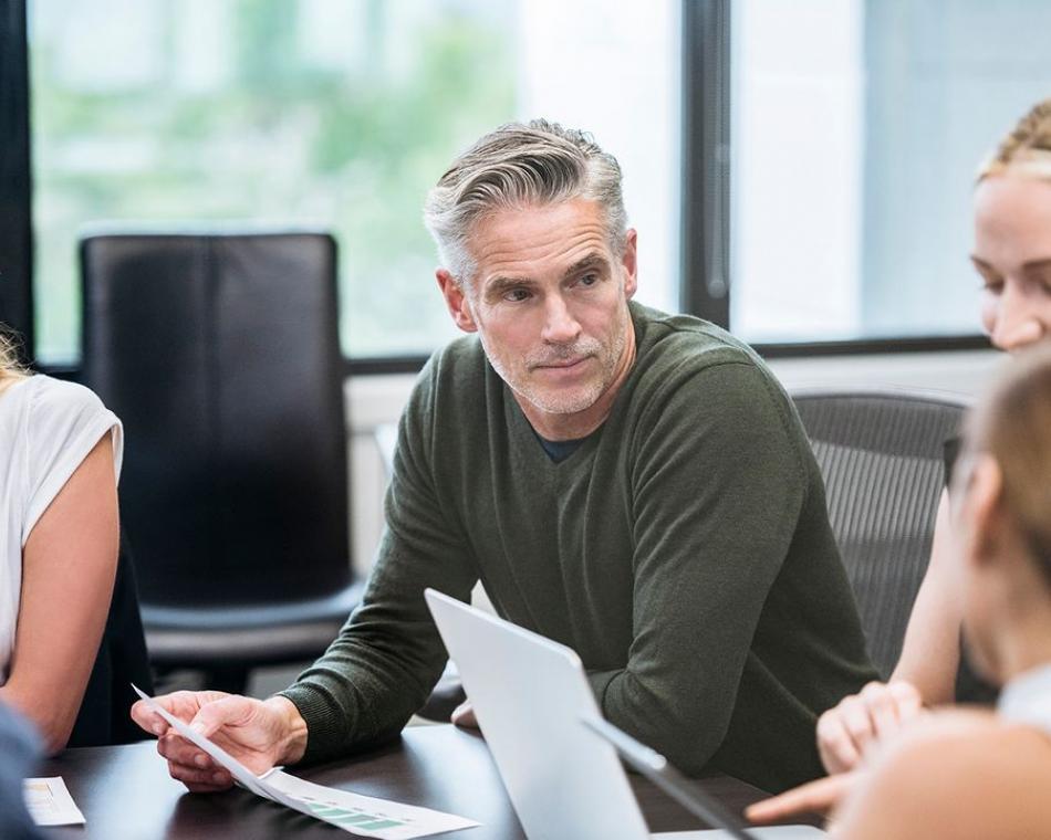 A man listening intently in a meeting
