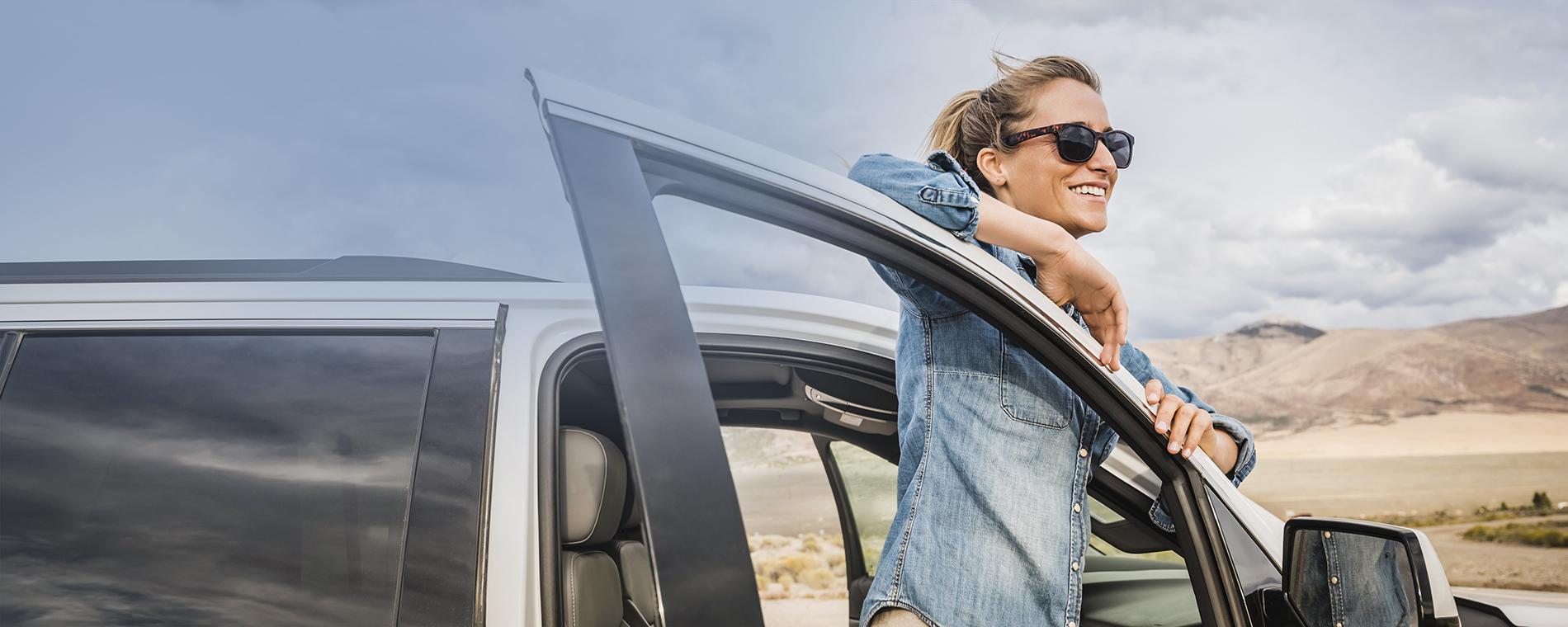 Confident woman securely covered by reliable car insurance